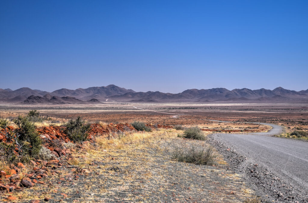 gravel road trip driving namibia travel desert landscape