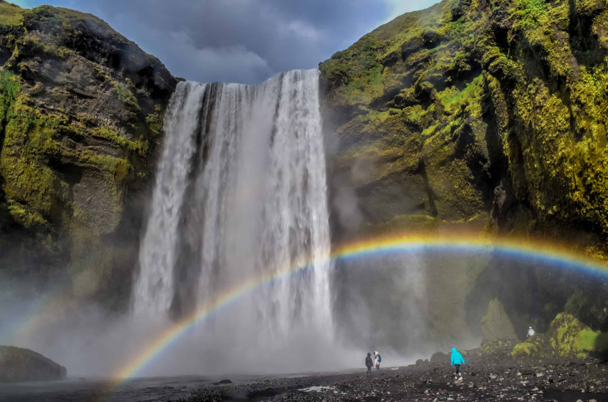 skogafoss waterfall iceland rainbow people