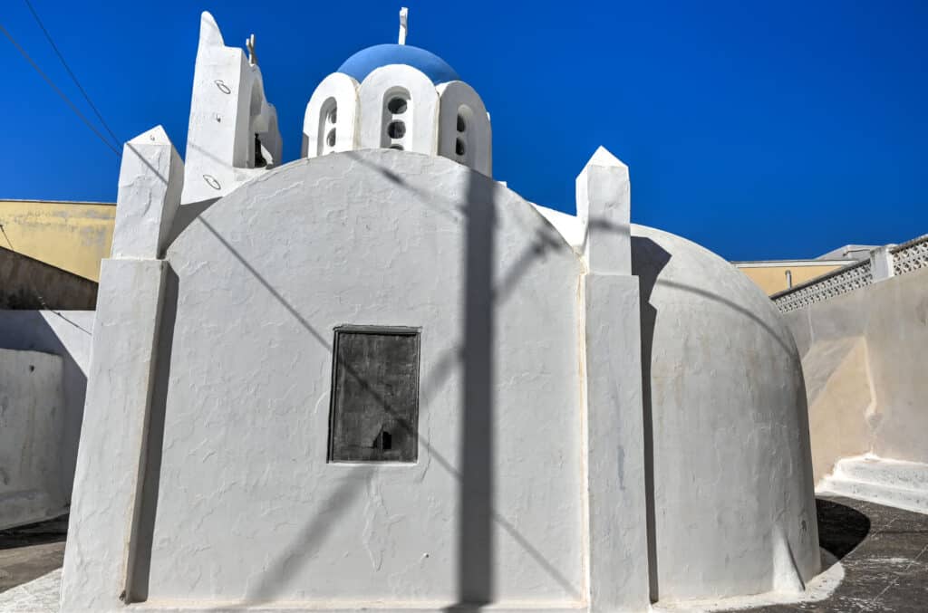 blue dome church and bells in pyrgos santorini